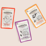 Three GOGOMA freeze-dried pet treat pouches arranged on a light beige background: a red-bordered Wild Boar & Fuji Apple pouch, an orange-bordered Elk Liver & Kabocha Squash pouch, and a purple-bordered Venison & Shiitake Mushroom pouch.